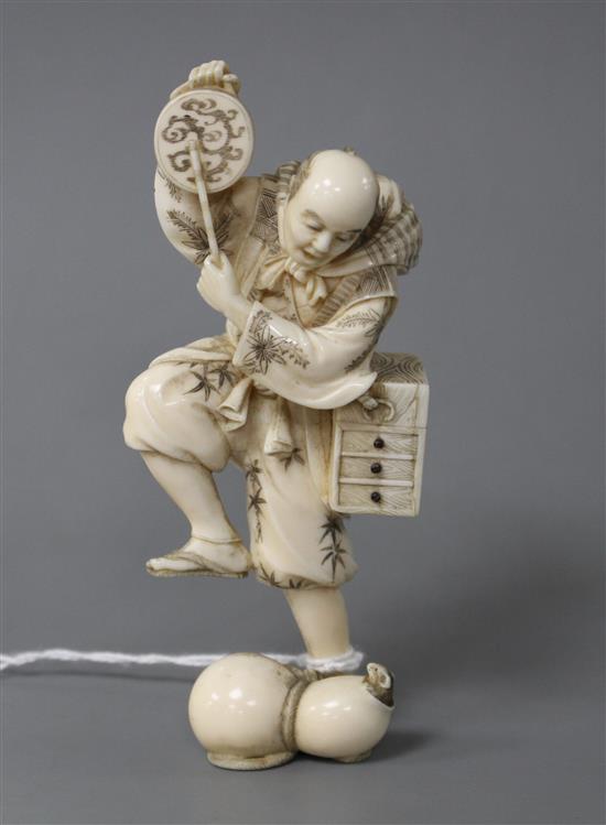 A Japanese carved ivory figure of an entertainer startled by a rat, late Meiji period, signed, height 11.5cm